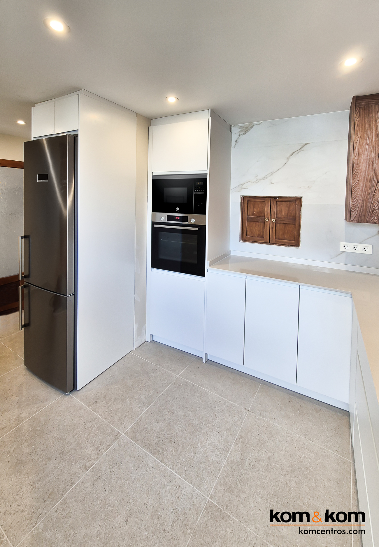 cocina moderna blanca con electrodom&eacute;sticos integrados.